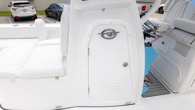 Slide: The Image of 2026 Tidewater 2700 Carolina Bay boat interior with white seating and control panel. - 9