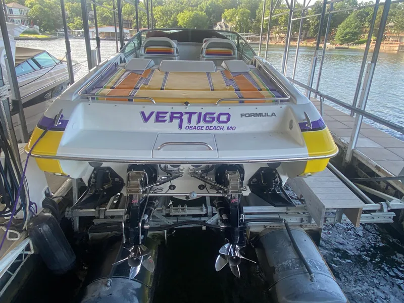 Slide: The Image of 2006 Formula 353 FASTech boat docked, featuring vibrant colors and dual propellers. - 13