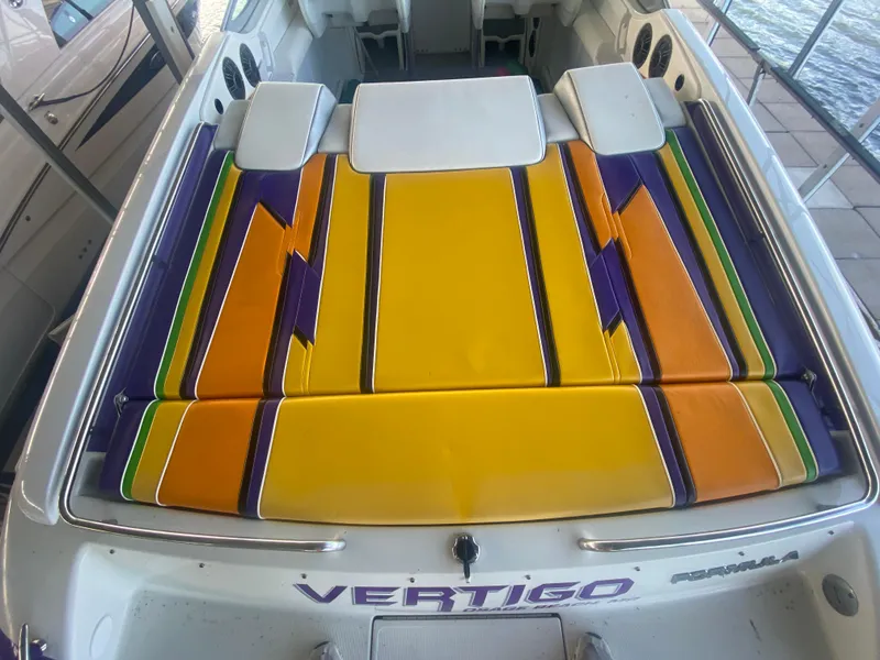 Slide: The Image of 2006 Formula 353 FASTech boat with vibrant yellow, orange, and purple seating. - 14