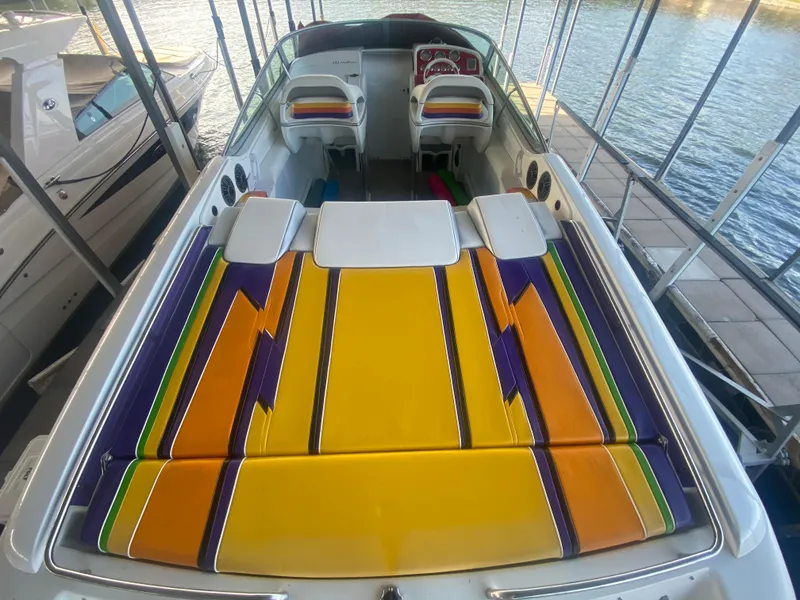 Slide: The Image of 2006 Formula 353 FASTech boat with vibrant, colorful seating and sleek design at a dock. - 15