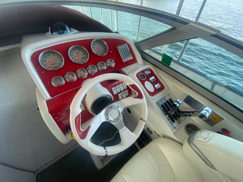 Slide: The Image of 2006 Formula 353 FASTech boat dashboard with red accents and multiple gauges. - 20