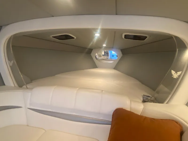 Slide: The Image of Interior of a 2006 Formula 353 FASTech boat, featuring a cozy cabin with white seating. - 29