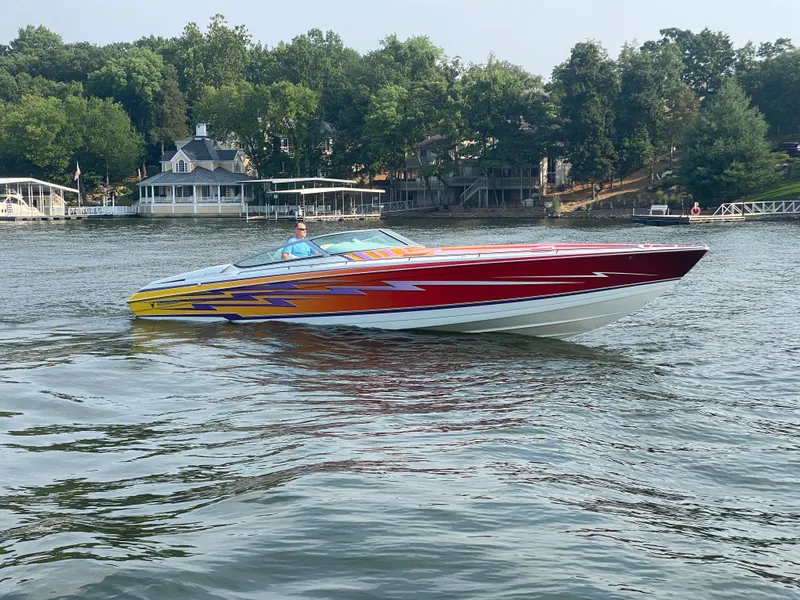 Slide: The Image of 2006 Formula 353 FASTech speedboat on a lake with vibrant graphics and scenic background. - 3