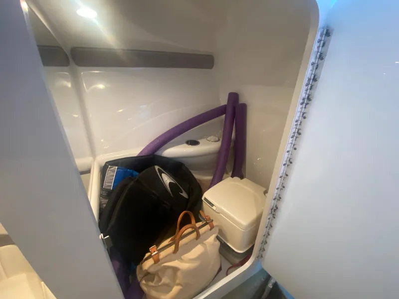 Slide: The Image of Interior of 2006 Formula 353 FASTech boat with storage items and portable toilet. - 31