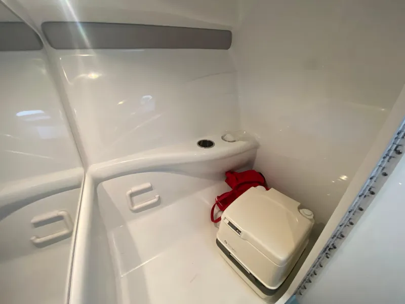 Slide: The Image of 2006 Formula 353 FASTech boat interior with portable toilet and storage area. - 32