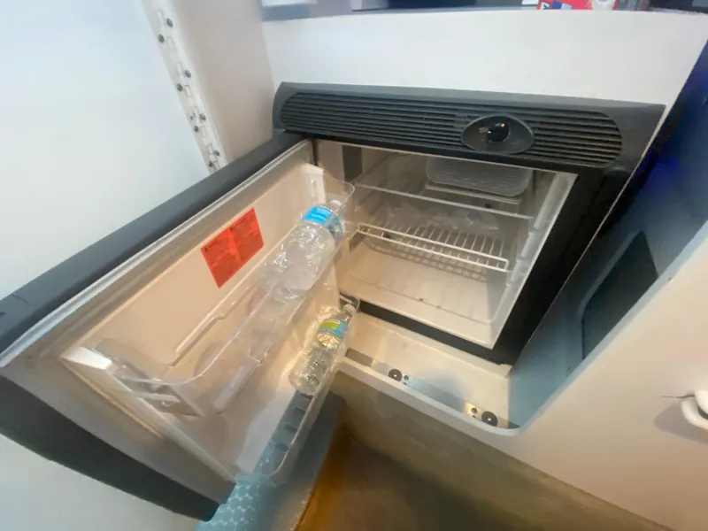 Slide: The Image of Open mini fridge in 2006 Formula 353 FASTech boat with water bottles inside. - 34