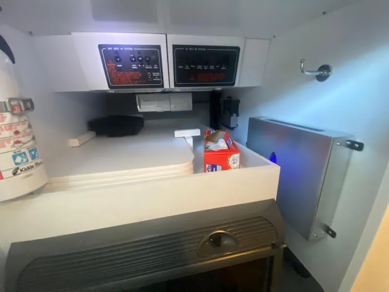 Slide: The Image of Interior of a 2006 Formula 353 FASTech boat with control panels and storage. - 35