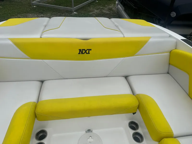 Slide: The Image of 2018 MasterCraft NXT22 boat interior with yellow and white seating. - 11