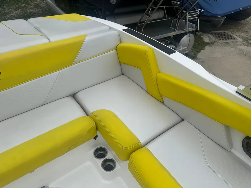Slide: The Image of 2018 MasterCraft NXT22 boat interior with yellow and white seating. - 12