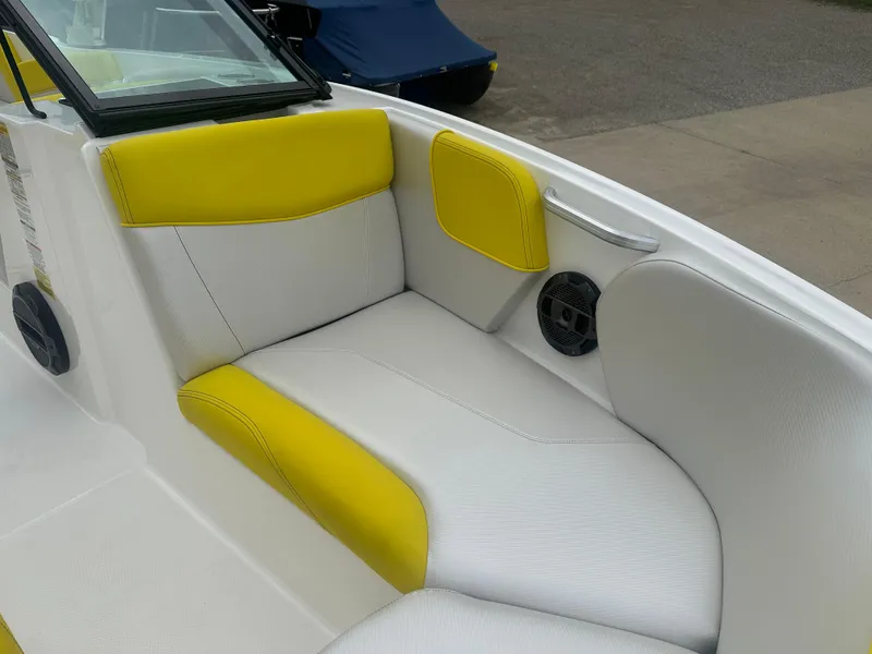 Slide: The Image of 2018 MasterCraft NXT22 boat interior with yellow and white seating. - 22