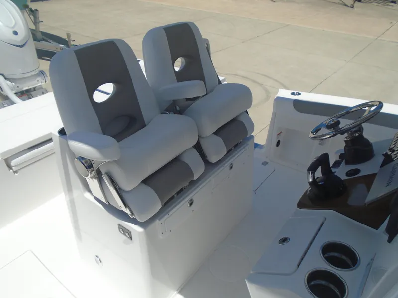 Slide: The Image of 2025 Caymas 291 boat cockpit with dual cushioned seats and steering wheel. - 12