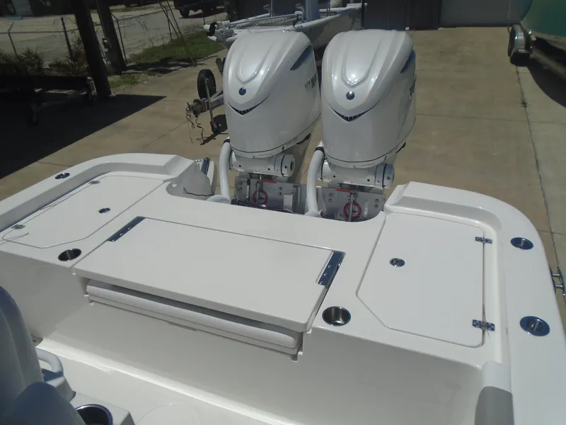 Slide: The Image of 2025 Caymas 291 boat with dual outboard engines, white deck, and storage compartments. - 13