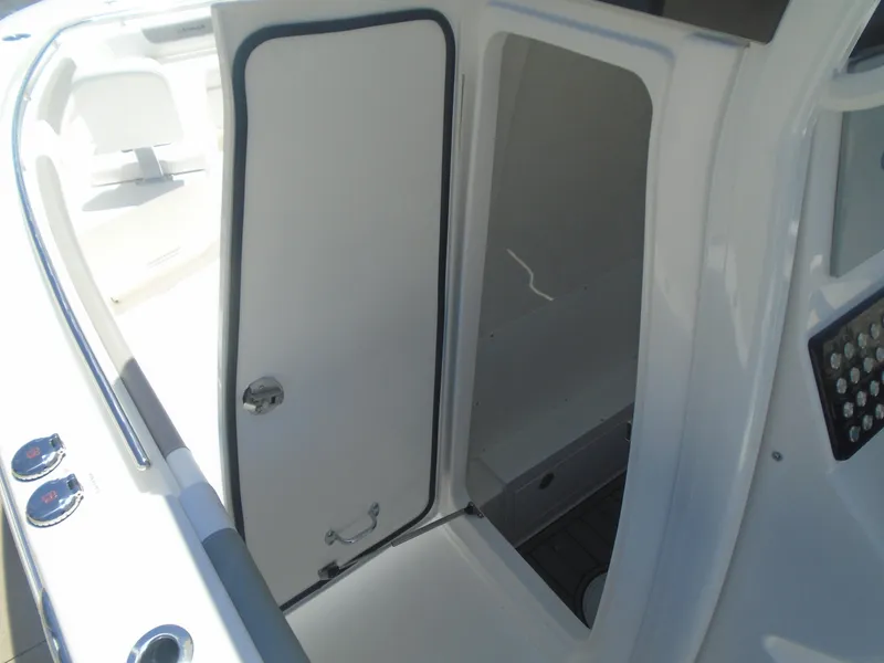 Slide: The Image of 2025 Caymas 291 boat interior with open cabin door, showcasing sleek design and modern features. - 21