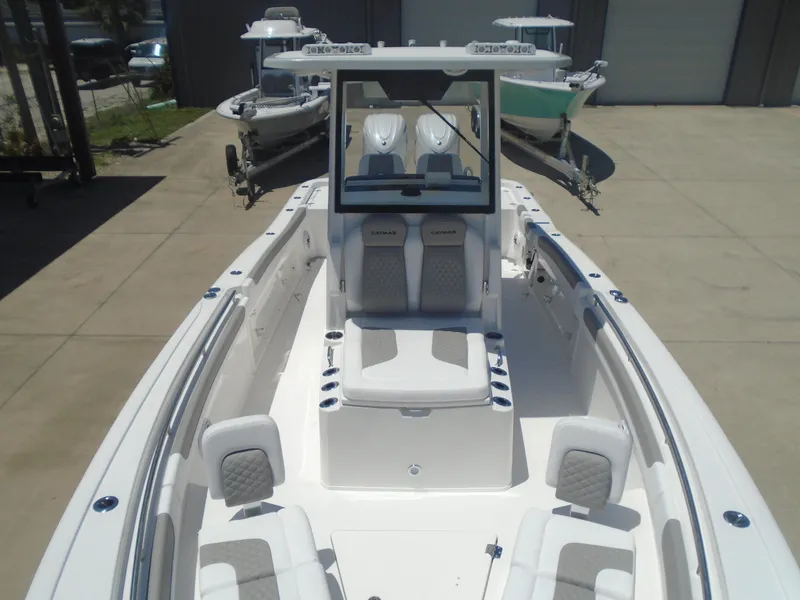 Slide: The Image of 2025 Caymas 291 boat with spacious seating and modern design in a marina setting. - 25