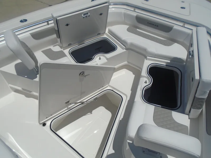 Slide: The Image of 2025 Caymas 291 boat interior with open storage compartments and seating. - 26