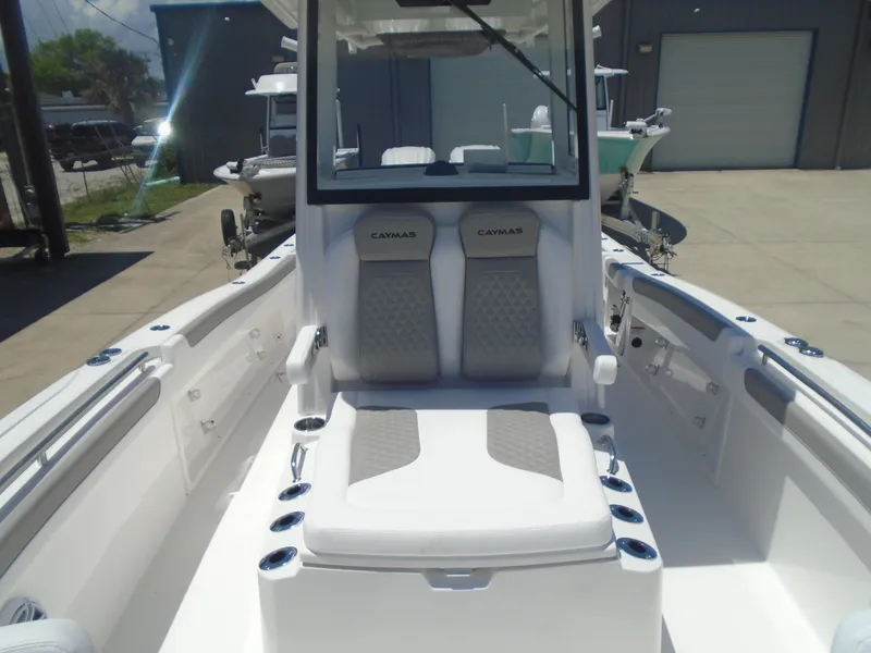 Slide: The Image of 2025 Caymas 291 boat interior with cushioned seating and modern design. - 28