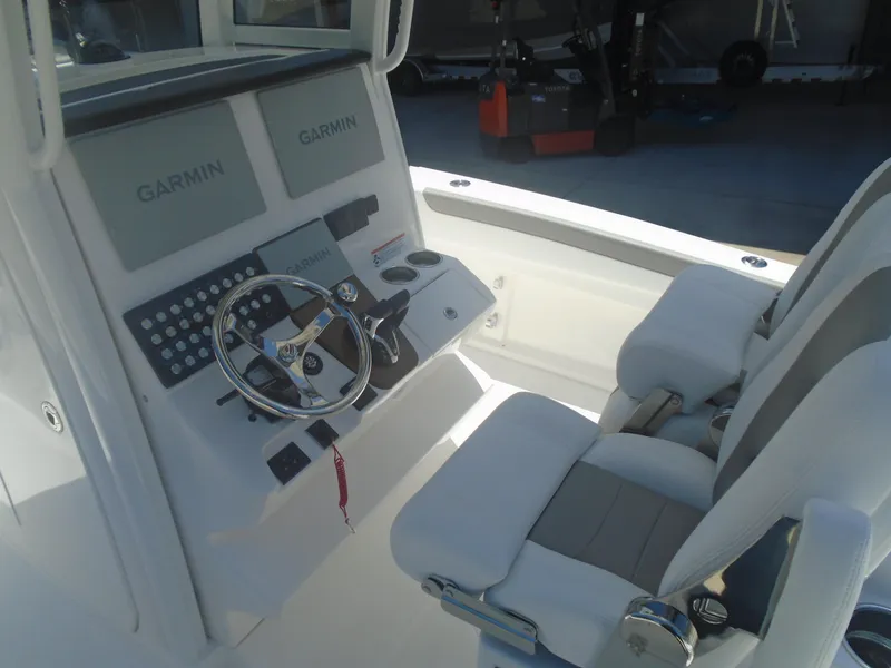 Slide: The Image of 2025 Caymas 291 boat cockpit with Garmin displays and dual seating. - 6