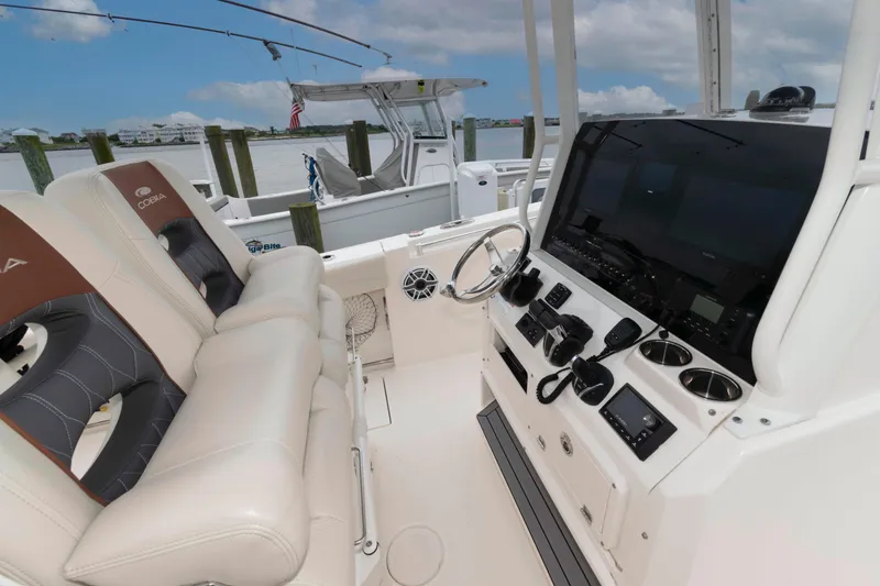 Slide: The Image of 2023 Cobia 280 Center Console boat interior with modern dashboard and seating. - 9