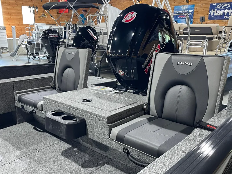 Slide: The Image of 2026 Lund 1775 Adventure Sport boat interior with Mercury engine and comfortable seating. - 9