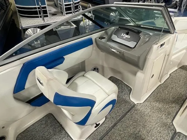 Slide: The Image of 2018 Chaparral 21 H2O Sport boat interior with blue and white seating and dashboard. - 11