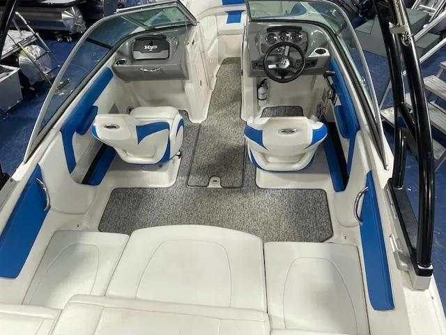 Slide: The Image of 2018 Chaparral 21 H2O Sport boat interior with blue and white seating and dashboard. - 12