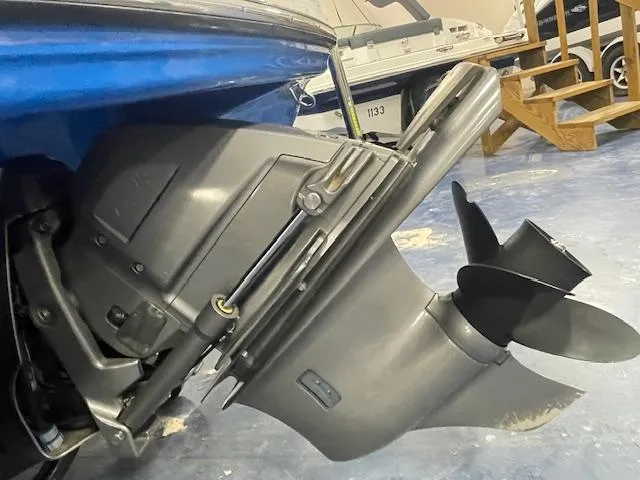 Slide: The Image of 2018 Chaparral 21 H2O Sport boat's outboard motor and propeller in a showroom. - 15
