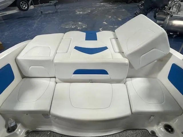Slide: The Image of 2018 Chaparral 21 H2O Sport boat interior with white and blue seating arrangement. - 8
