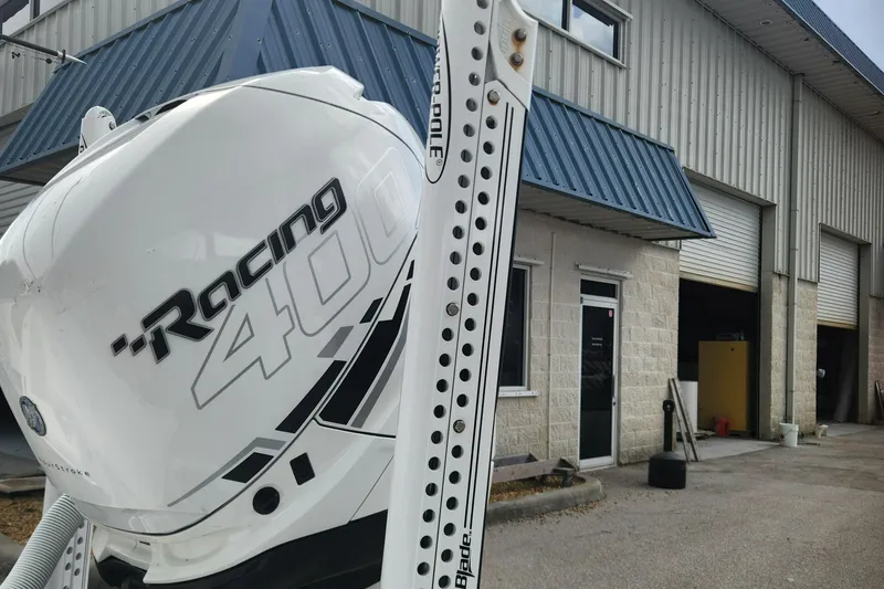 Slide: The Image of 2018 Islamorada Boatworks Morada 24 with Racing 400 engine near industrial building. - 12