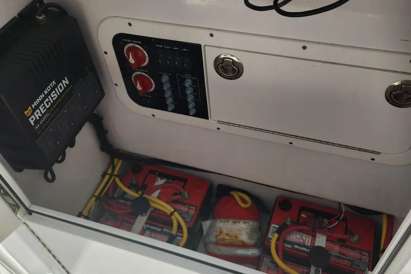Slide: The Image of Electrical panel and batteries inside a 2018 Islamorada Boatworks Morada 24. - 13
