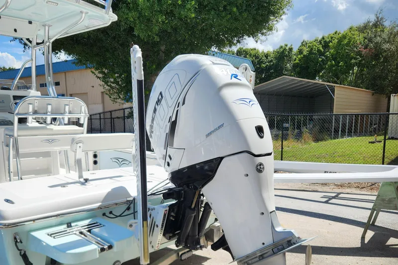 Slide: The Image of 2018 Islamorada Boatworks Morada 24 with Mercury outboard engine, parked outdoors. - 14