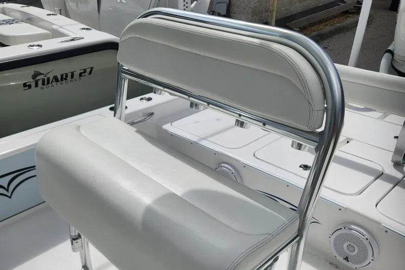 Slide: The Image of 2018 Islamorada Boatworks Morada 24 interior with white seating and chrome details. - 8