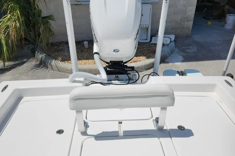 Slide: The Image of 2018 Islamorada Boatworks Morada 24 with outboard motor and seating, docked outdoors. - 9