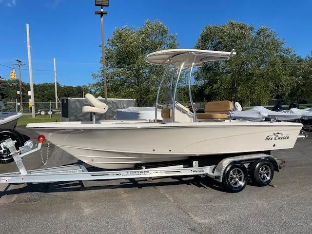 The Image of 2024 Sea Chaser LX boat on trailer, parked outdoors under clear blue sky. - 1