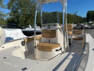 Slide: The Image of 2024 Sea Chaser LX boat with center console, beige seating, and stainless steel railings. - 3