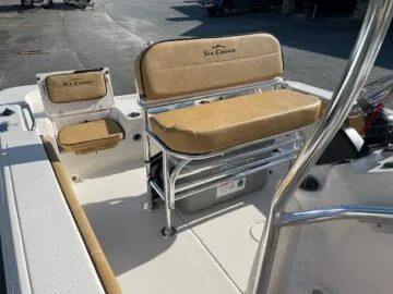 Slide: The Image of 2024 Sea Chaser LX boat interior with tan seating and storage compartments. - 6