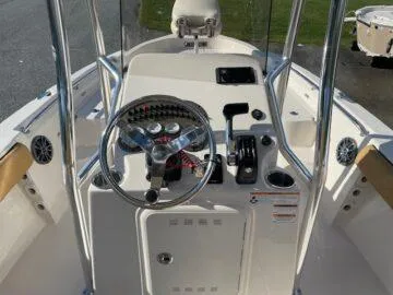 Slide: The Image of 2024 Sea Chaser LX boat console with steering wheel and controls. - 7