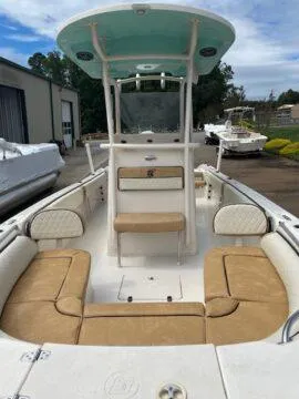Slide: The Image of 2023 Carolina Skiff Ultra Elite boat with tan seating and a center console. - 3