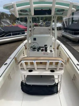 Slide: The Image of 2023 Carolina Skiff Ultra Elite boat interior with console and seating, docked near other boats. - 4