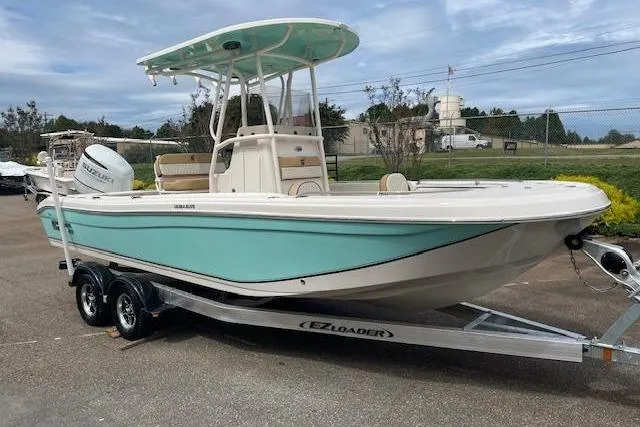 Slide: The Image of 2023 Carolina Skiff Ultra Elite boat on trailer, featuring a sleek design and mint green hull. - 9