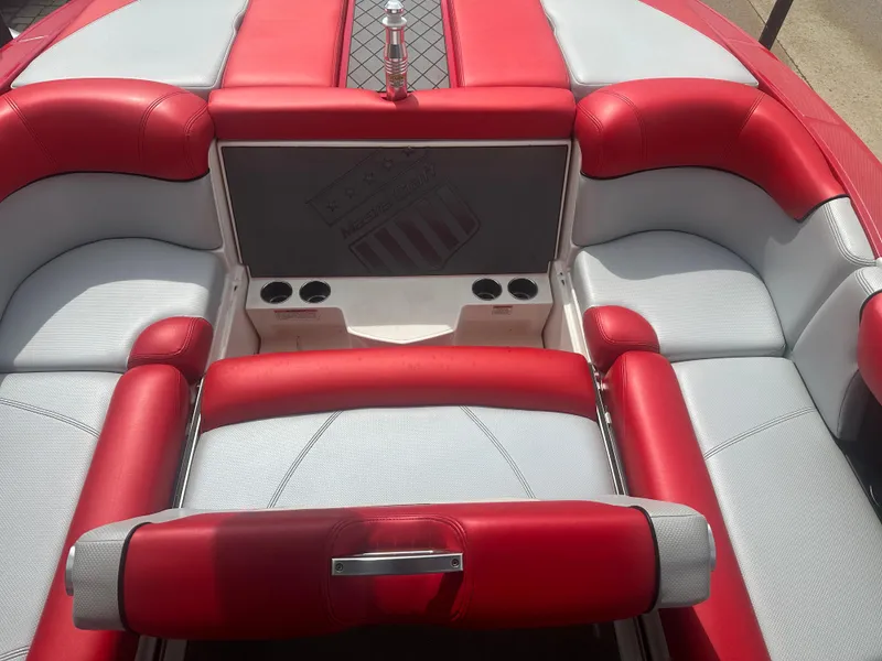 Slide: The Image of 2015 MasterCraft X10 boat interior with red and gray seating. - 10