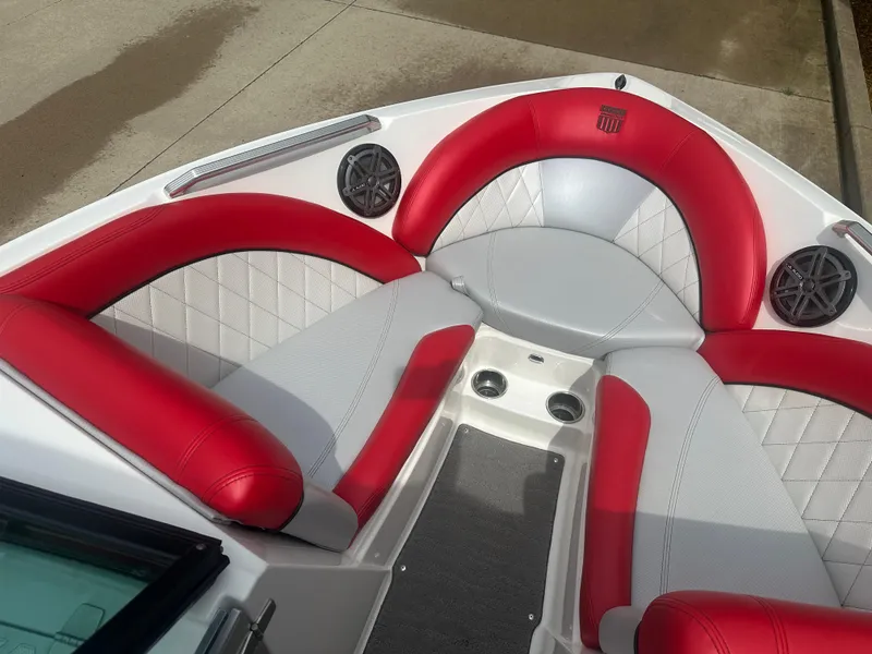 Slide: The Image of 2015 MasterCraft X10 boat interior with red and gray seating and speakers. - 14