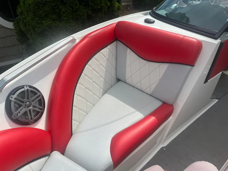 Slide: The Image of 2015 MasterCraft X10 boat interior with red and white seating and JL Audio speaker. - 15