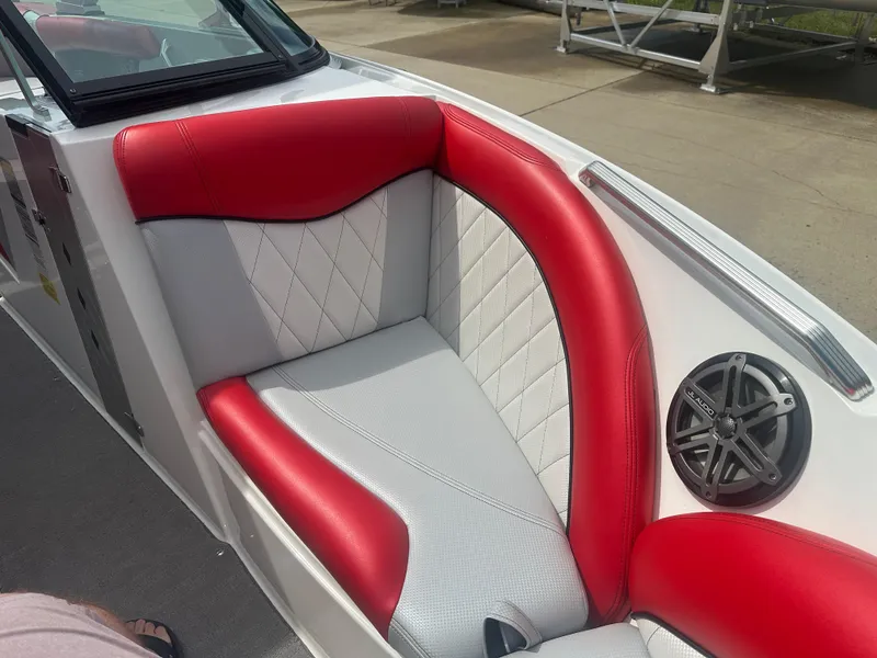 Slide: The Image of 2015 MasterCraft X10 boat interior with red and white seating and speaker. - 16