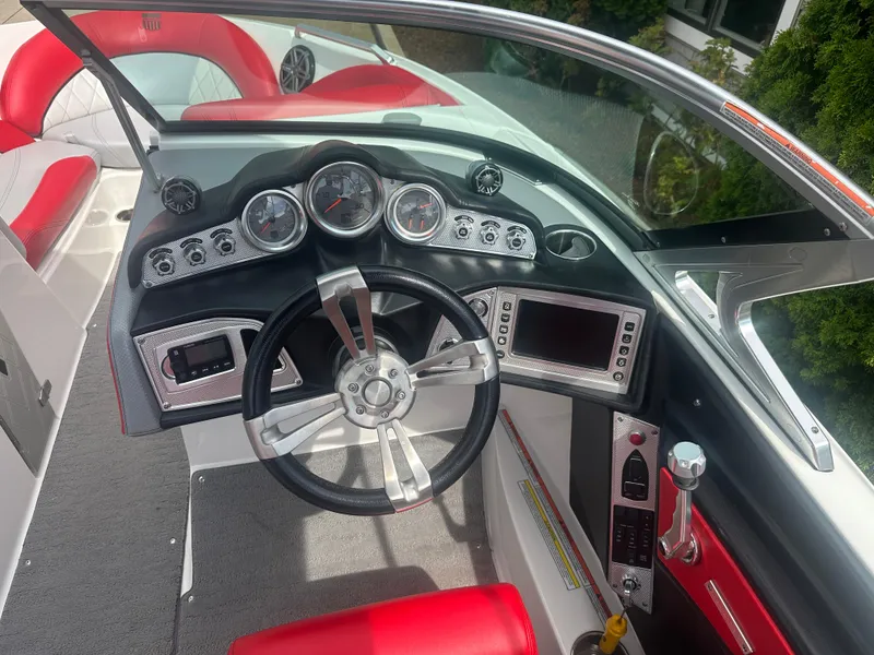 Slide: The Image of 2015 MasterCraft X10 boat dashboard with steering wheel and control panel. - 5