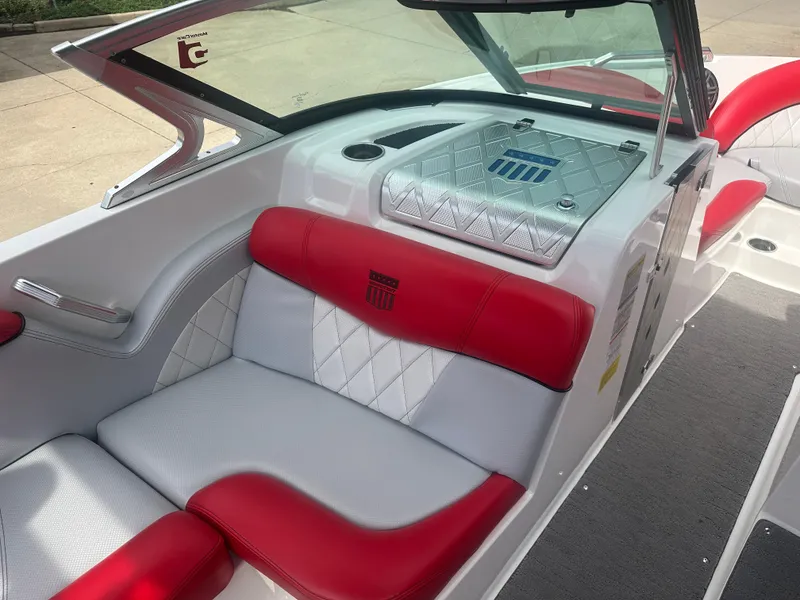 Slide: The Image of 2015 MasterCraft X10 boat interior with red and white seating, diamond stitching, and sleek design. - 6