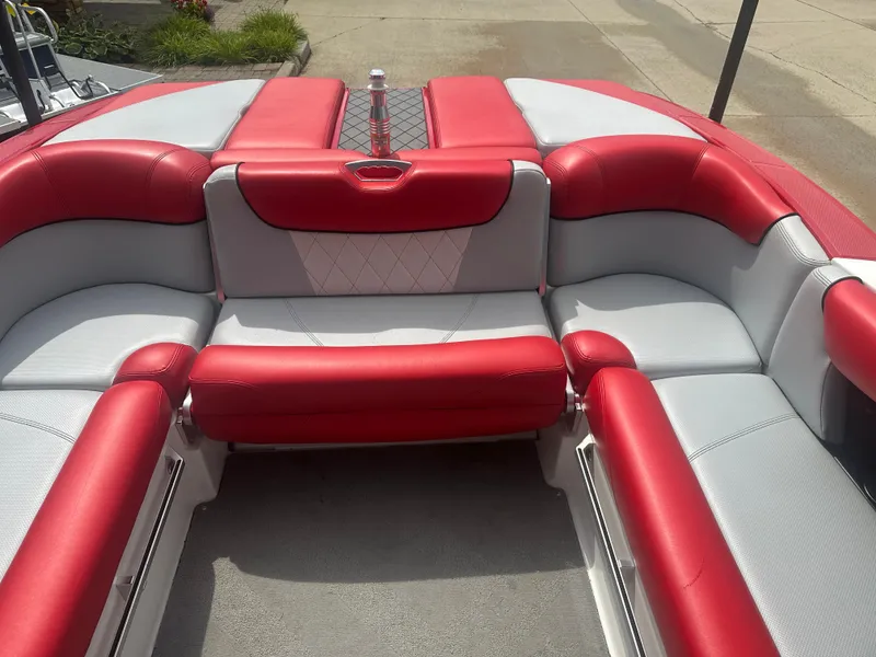 Slide: The Image of 2015 MasterCraft X10 boat interior with red and gray seating, featuring a central cup holder. - 8