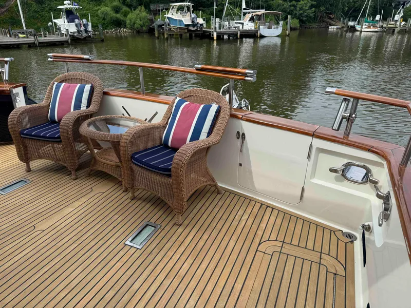 Slide: The Image of Deck of 2002 Marlow 70E yacht with wicker chairs and river view. - 11