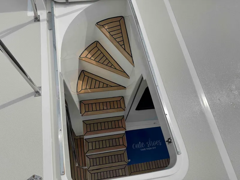 Slide: The Image of Staircase on 2002 Marlow 70E yacht with wooden steps and safety railing. - 12