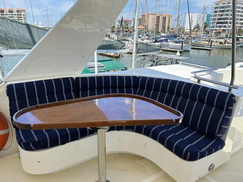 Slide: The Image of Luxury seating area on 2002 Marlow 70E yacht with marina view. - 17