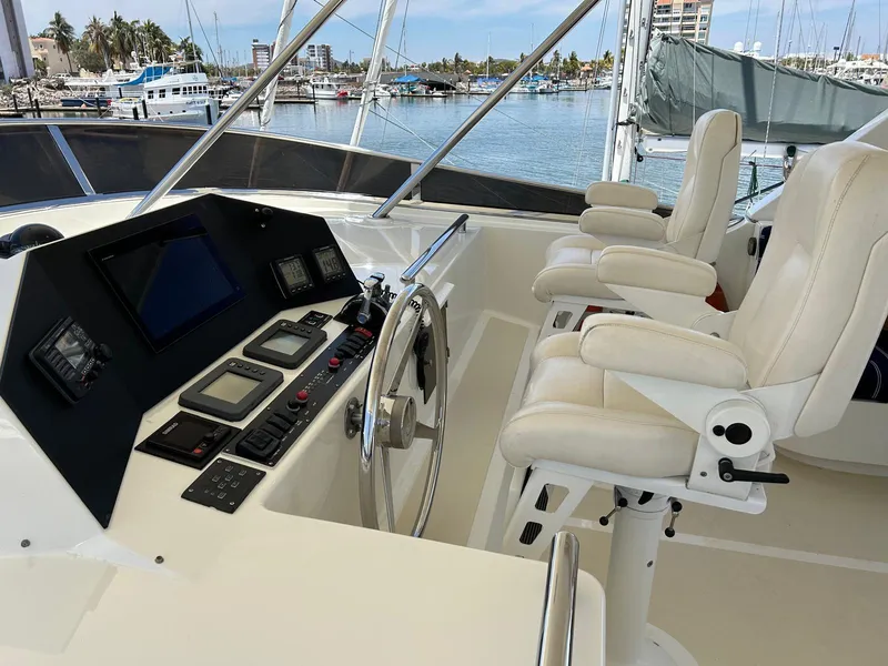 Slide: The Image of Luxury yacht helm with white captain chairs and navigation controls, Marlow 70E, 2002 model. - 19